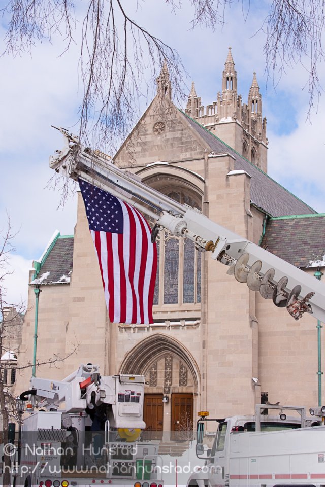 A flag hangs from a cherry picker in front of the House of Hope Presbyterian Church on Summit Avenue
